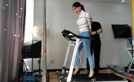 Bound And Gagged Asian Babe Walks On Treadmill In High Heels